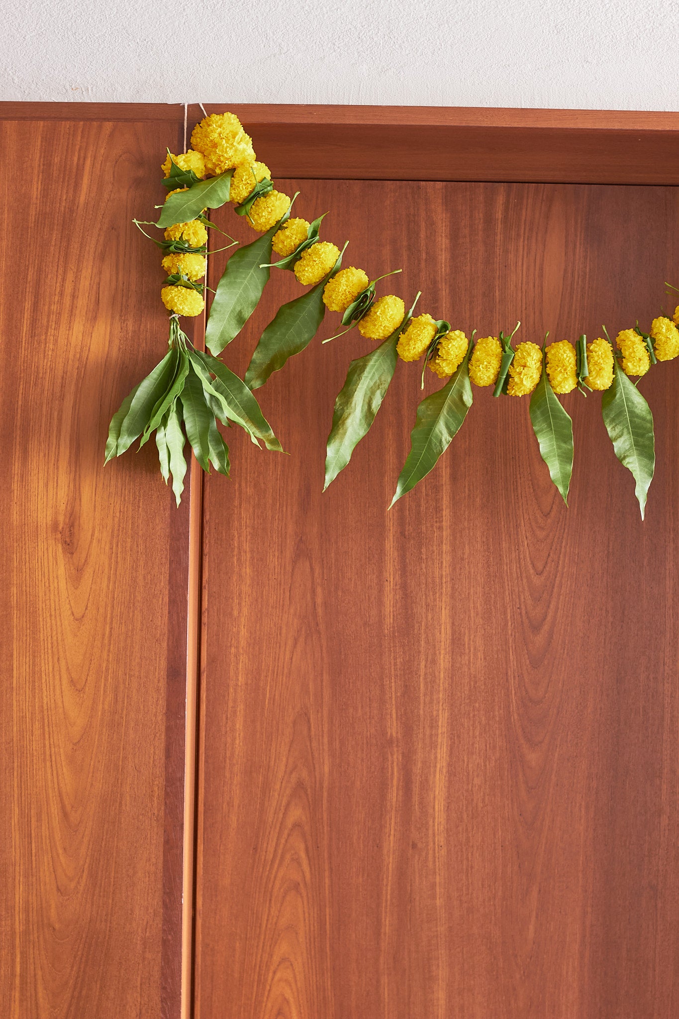 Buy Yellow Ambapala Toran by Mahua Floral Studio.