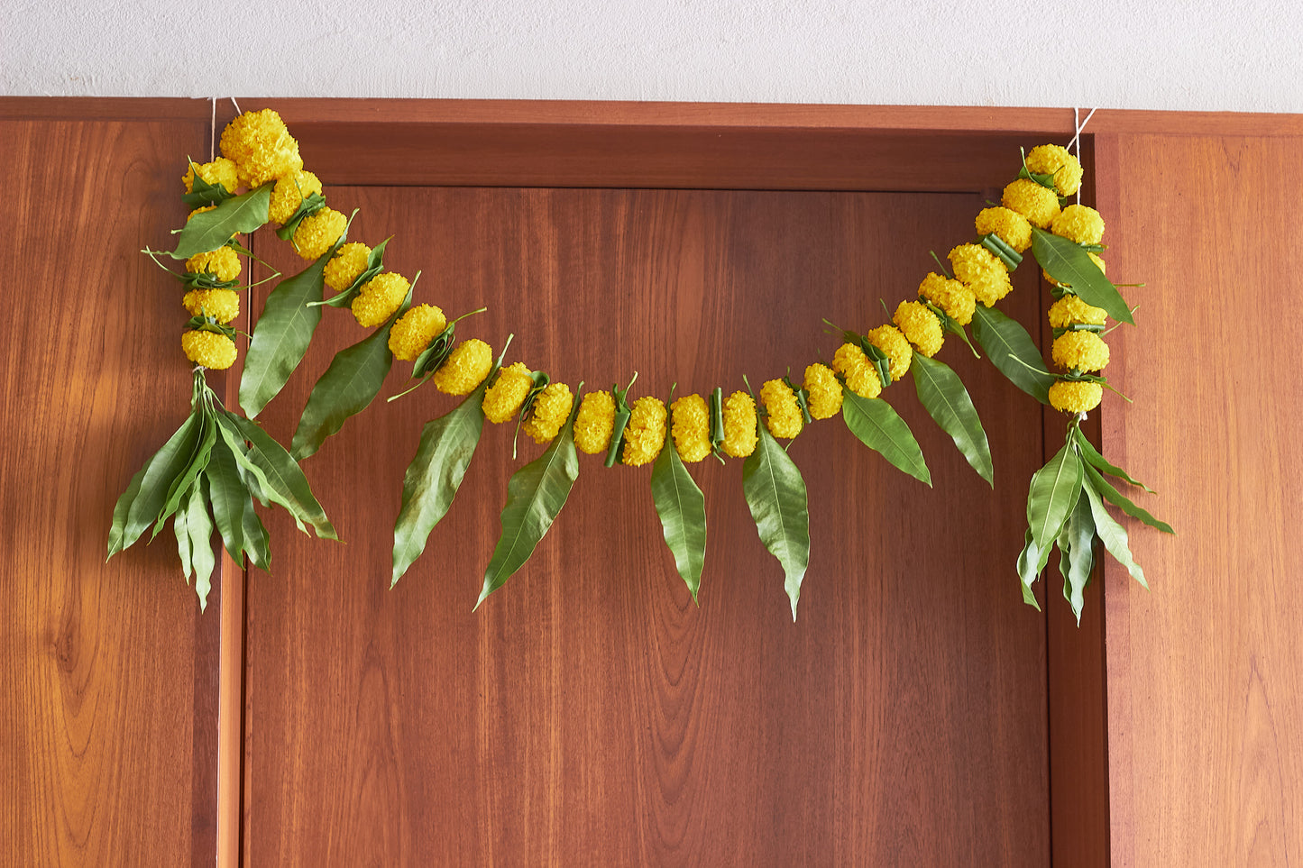 Buy Yellow Ambapala Toran by Mahua Floral Studio.