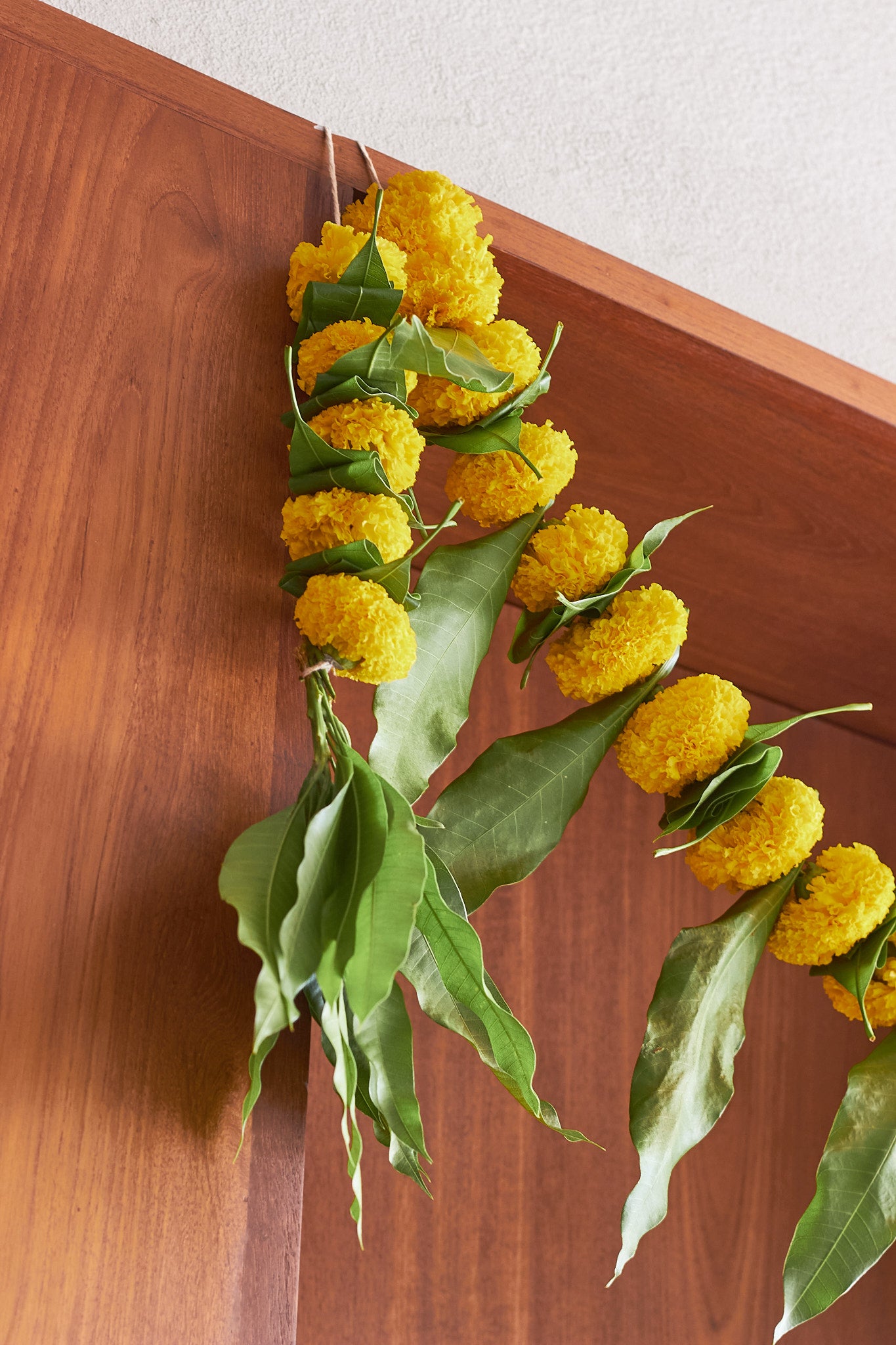 Buy Yellow Ambapala Toran by Mahua Floral Studio.
