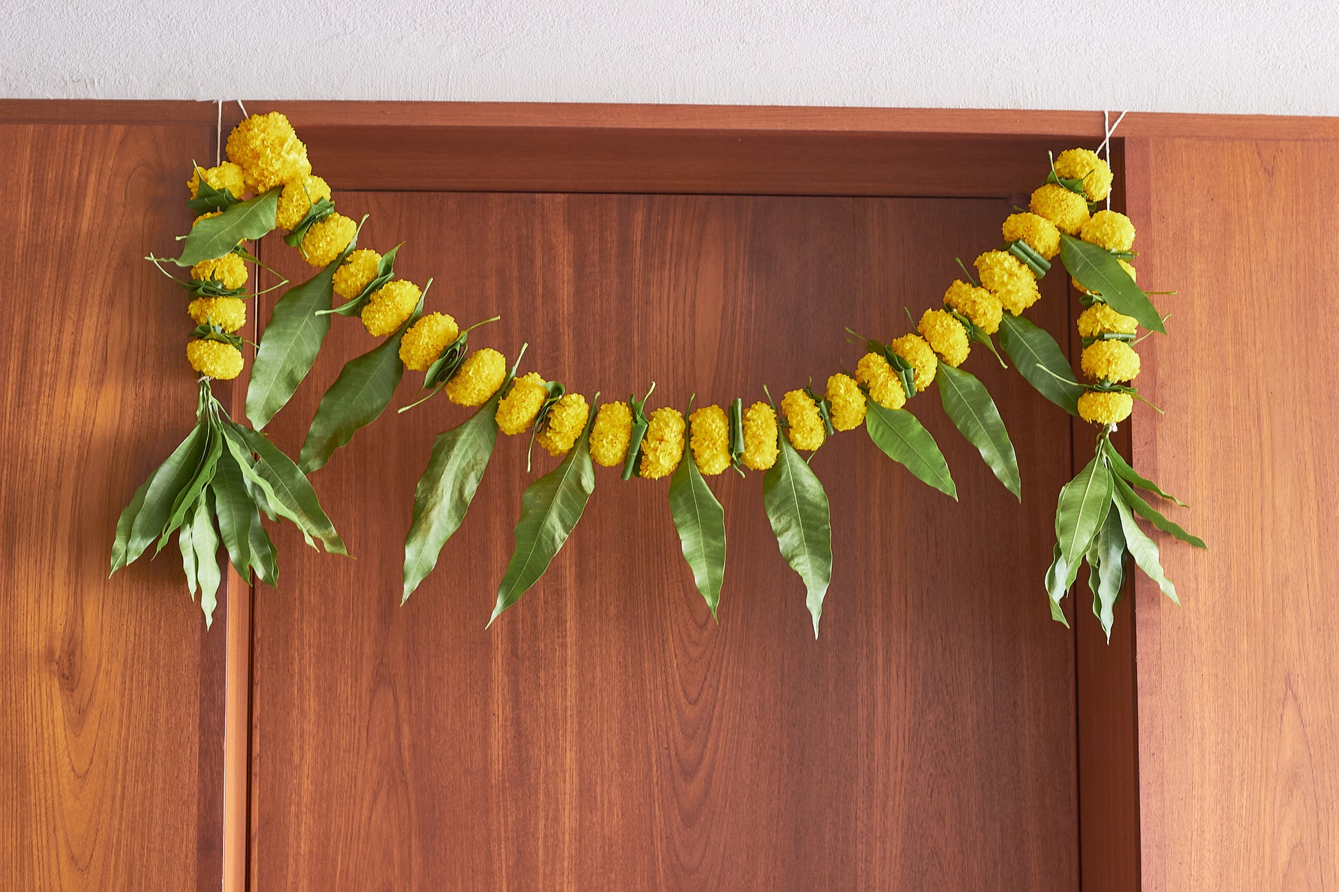 Buy Yellow Ambapala Toran by  Mahua Floral Studio.