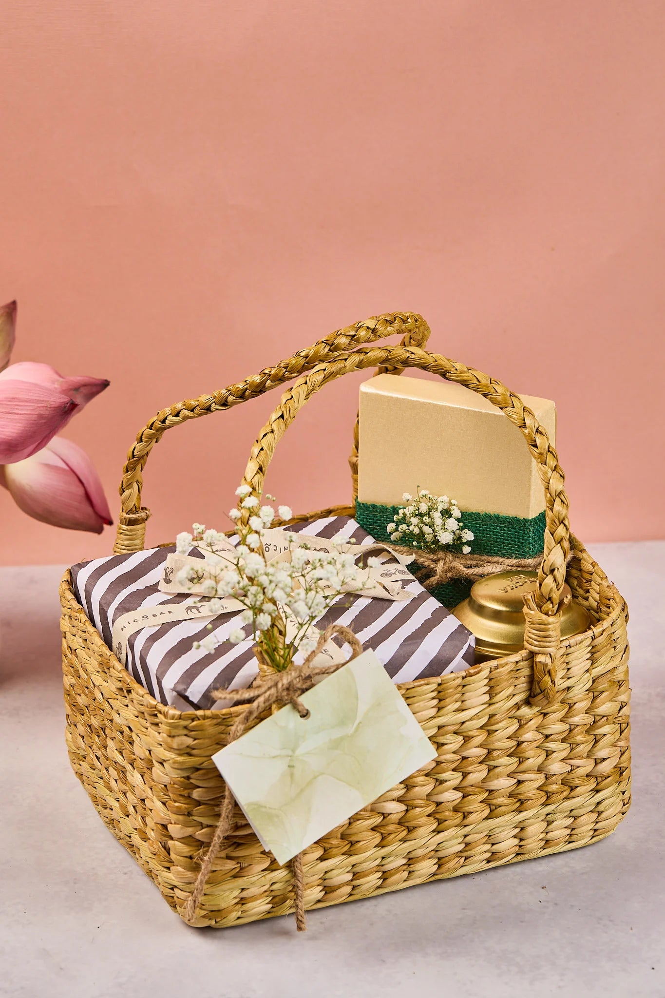 Water hyacinth basket with nicobar mugs and khajoor box and herbal tea from Sancha tea company with a gift card attached.
