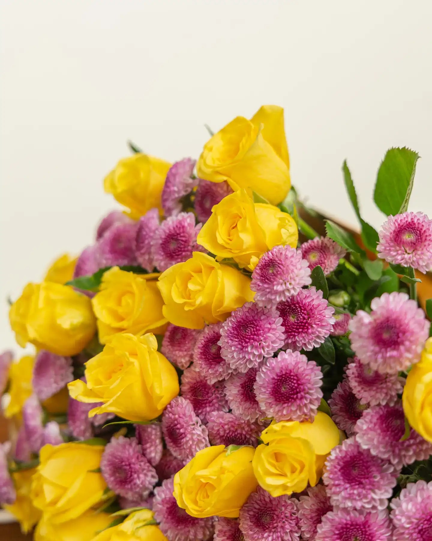 Bouquet of yellow and pink flowers on a light background