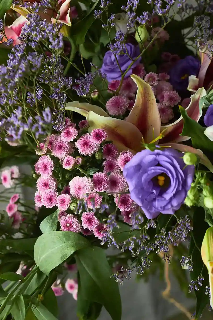 Bouquet of flowers with purple, pink, and green colors.